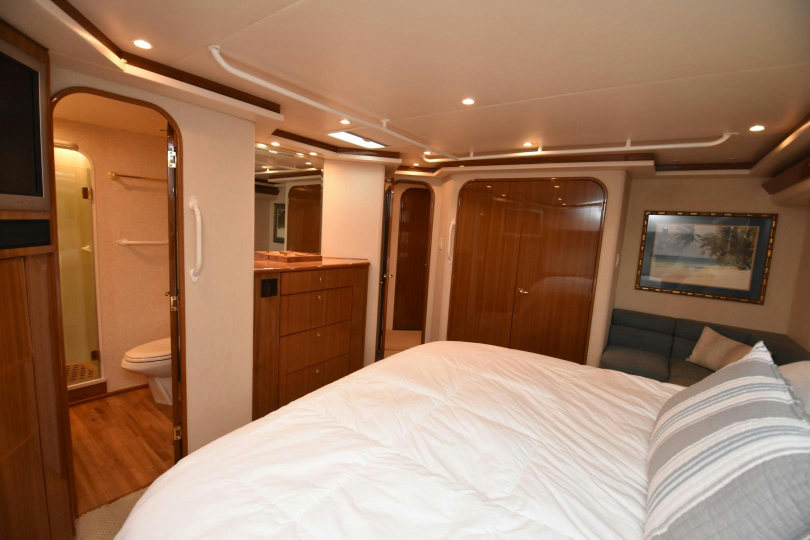 a bedroom with a bed and a mirror aboard Hoof Hearted Yacht for Sale