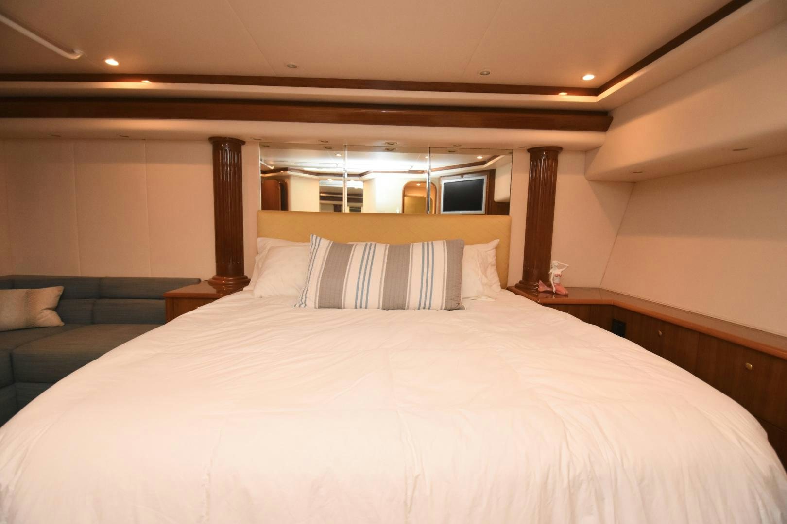 a bed with a white bed spread aboard Hoof Hearted Yacht for Sale
