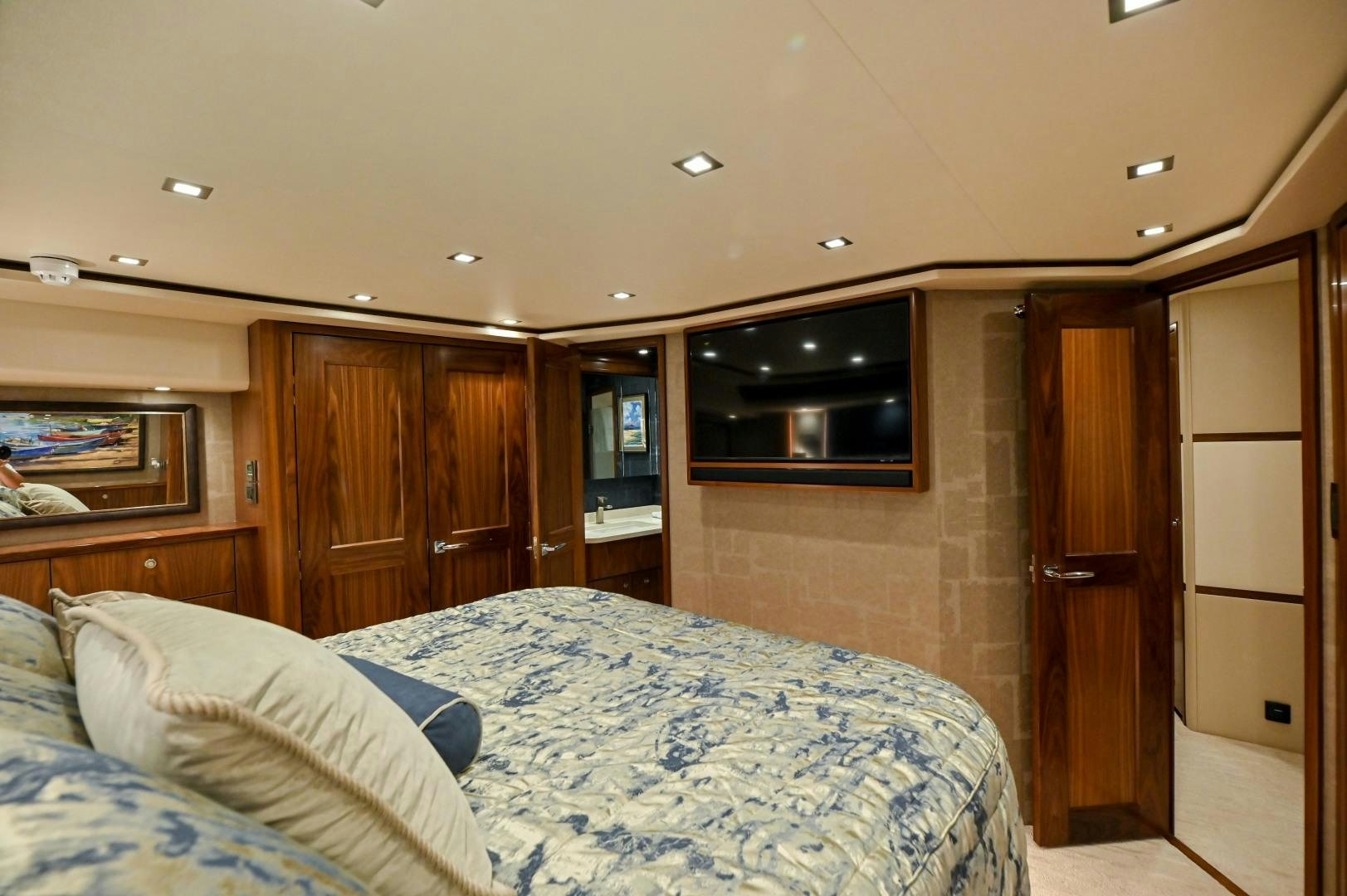 a bedroom with wood cabinets aboard EL LOBO Yacht for Sale