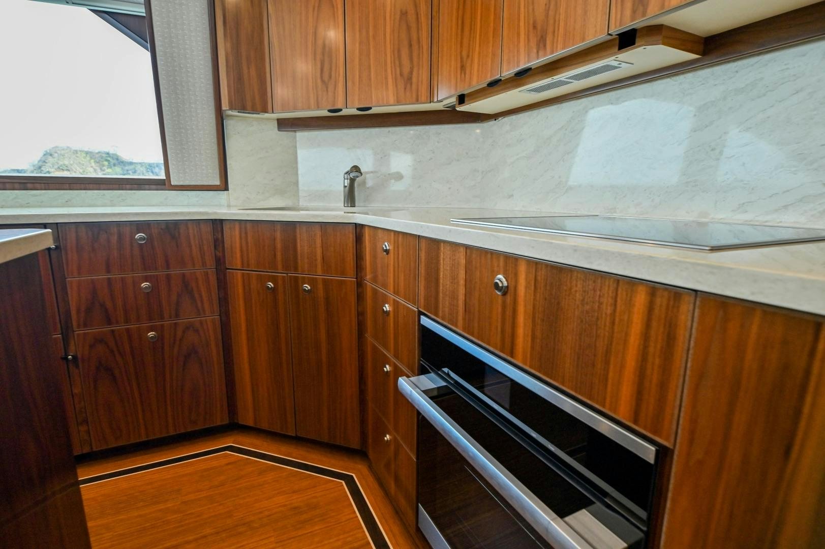 a kitchen with wooden cabinets aboard EL LOBO Yacht for Sale
