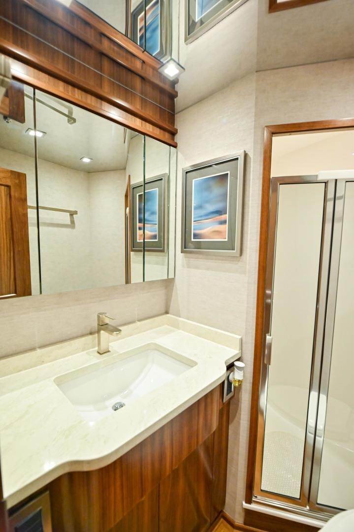 a bathroom with a sink and mirror aboard EL LOBO Yacht for Sale