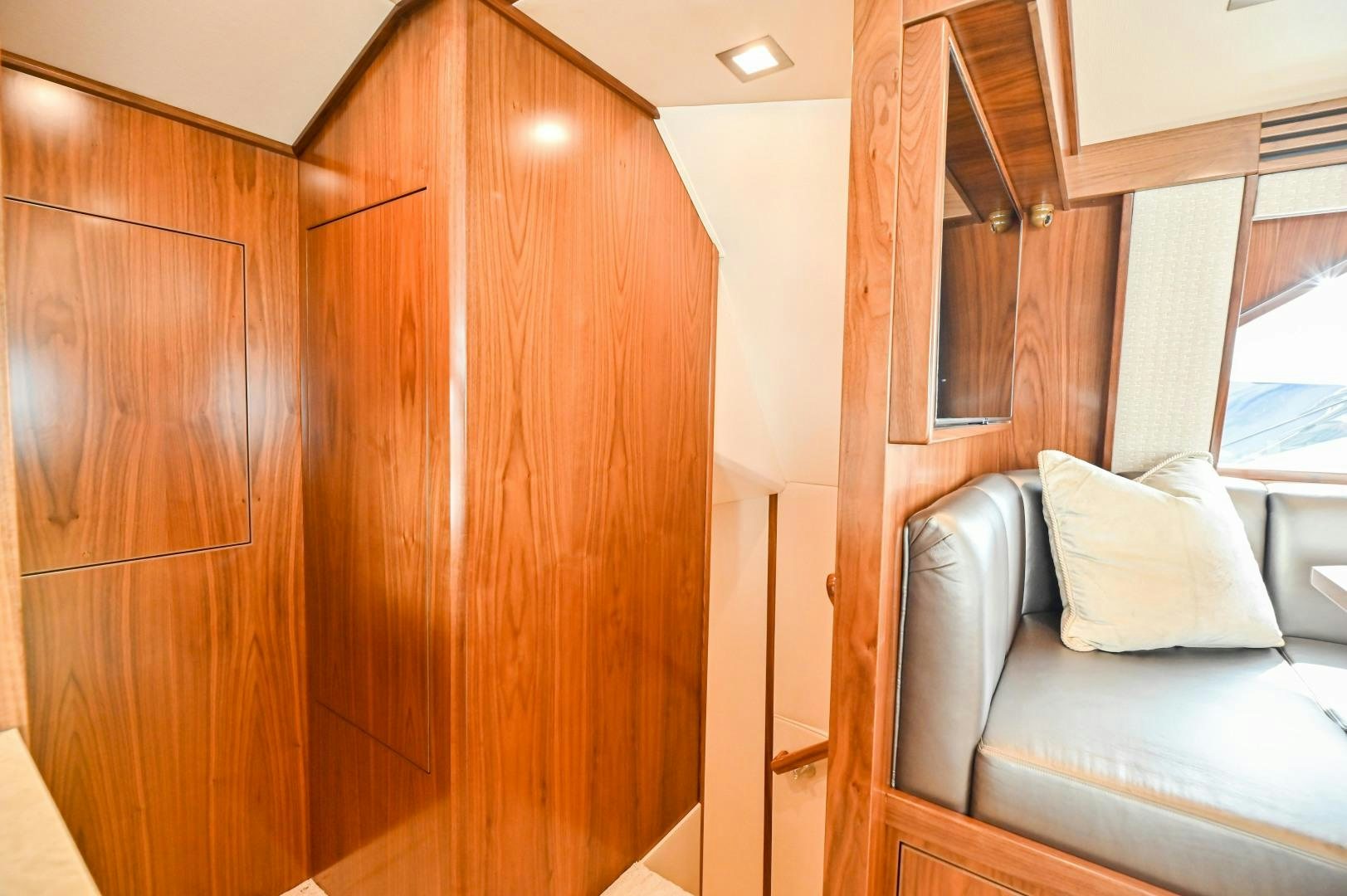 a room with a bed and a wood cabinet aboard EL LOBO Yacht for Sale