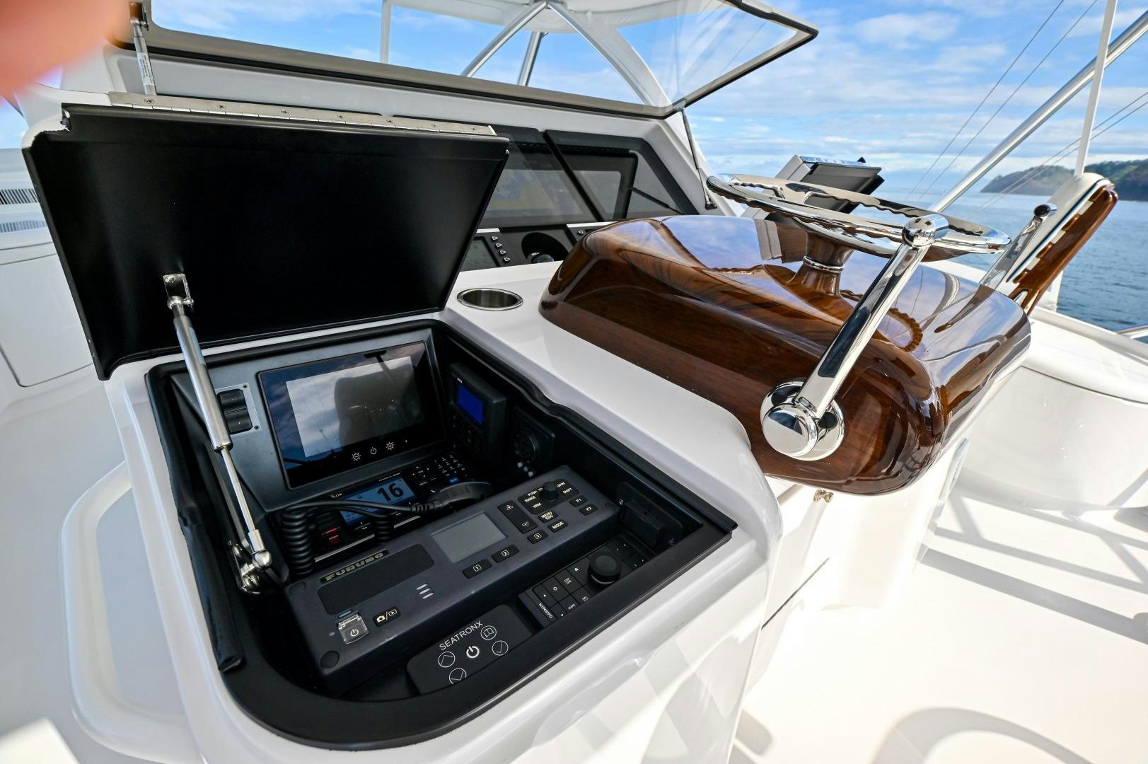 a steering wheel and dashboard of a boat aboard EL LOBO Yacht for Sale