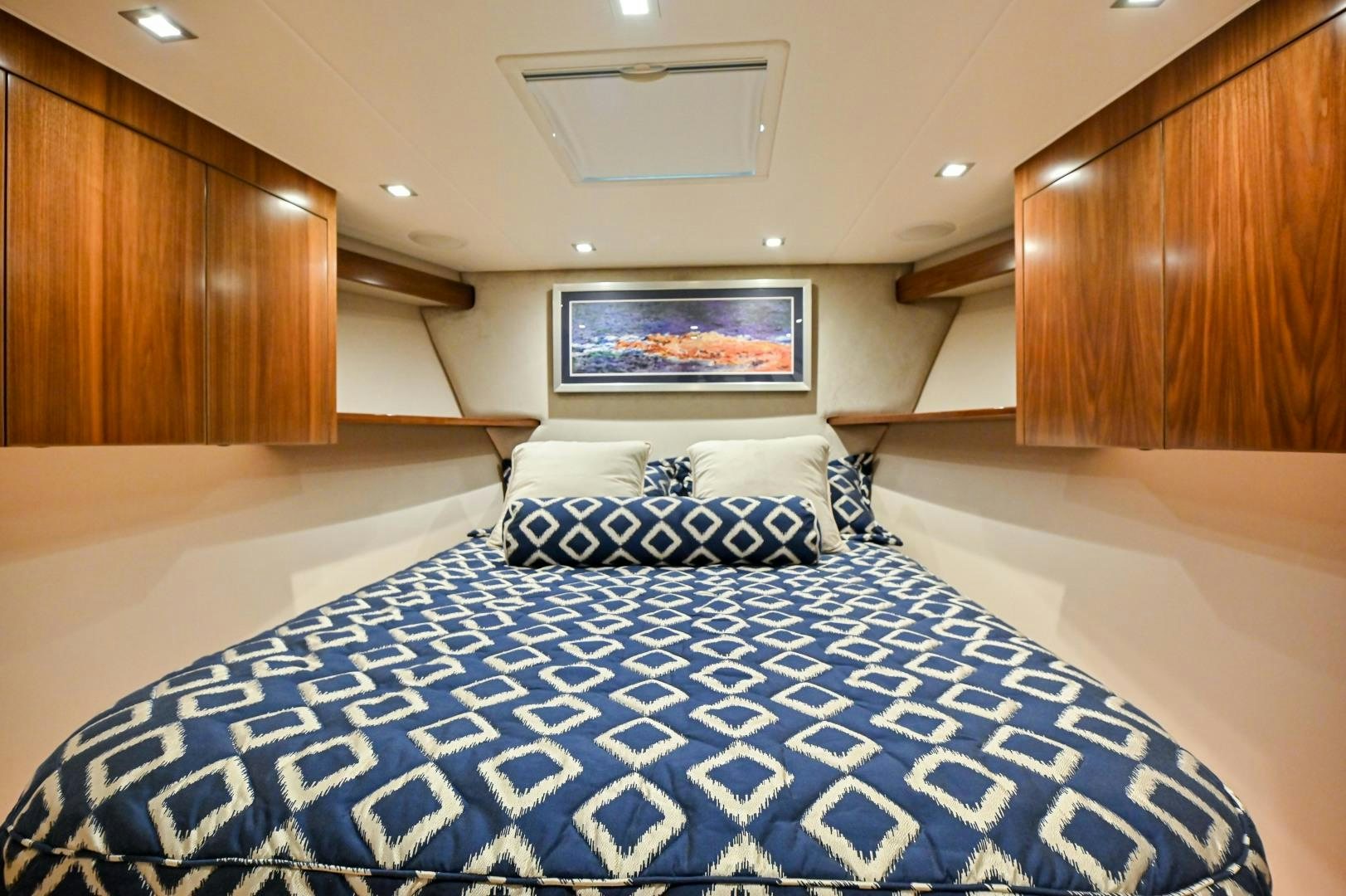 a bed with a blue and white checkered blanket aboard EL LOBO Yacht for Sale