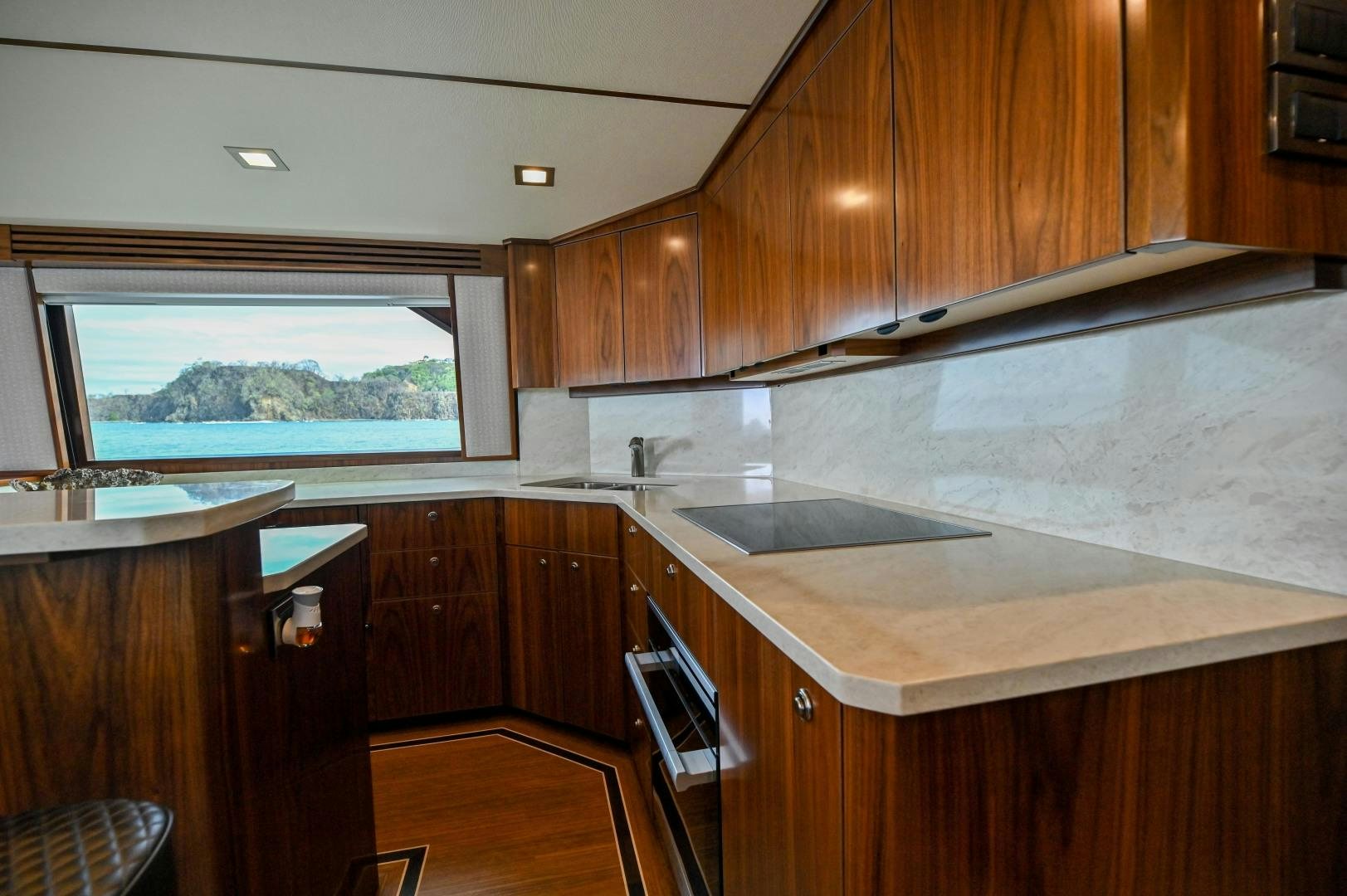 a kitchen with wooden cabinets aboard EL LOBO Yacht for Sale