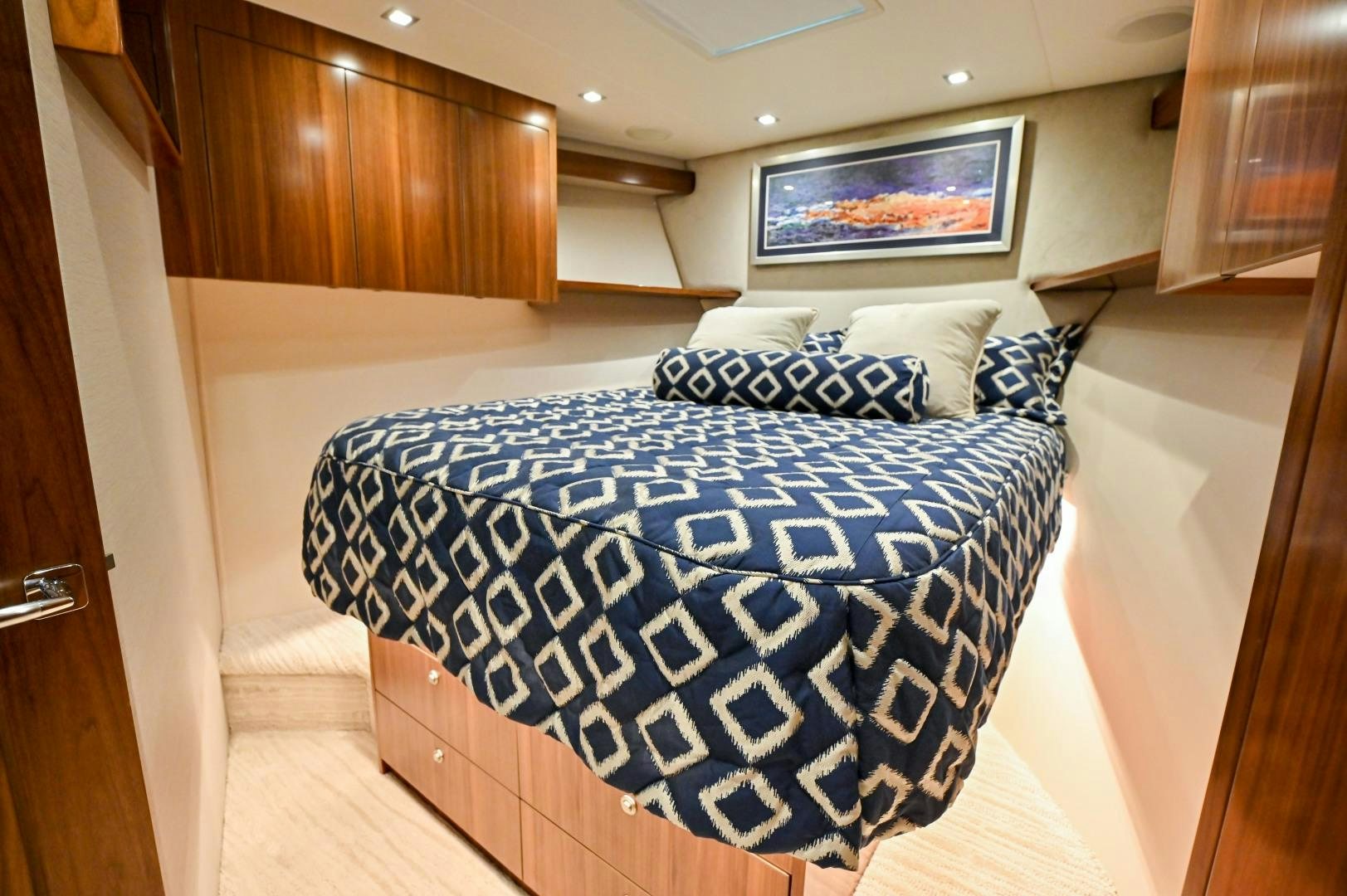 a bed with blue and white sheets aboard EL LOBO Yacht for Sale