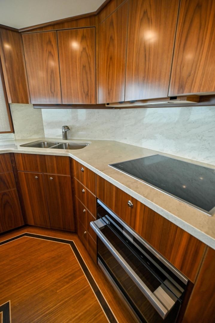 a kitchen with wooden cabinets aboard EL LOBO Yacht for Sale