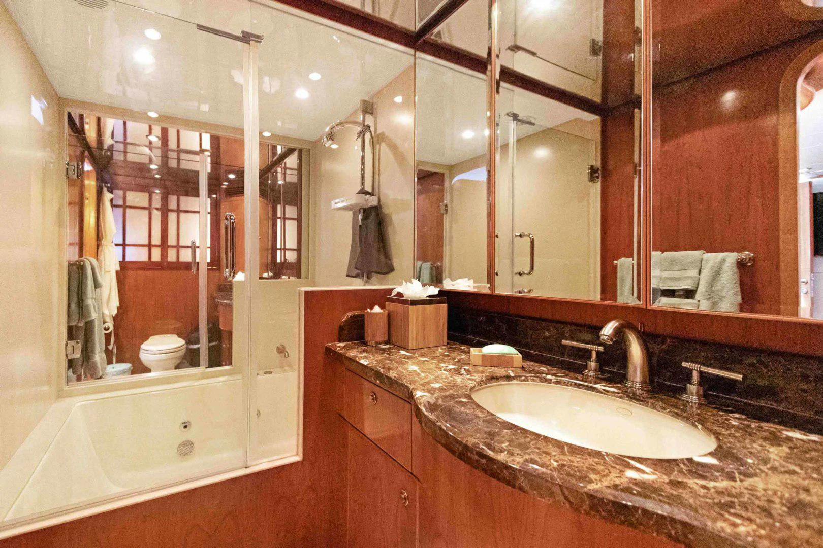 a bathroom with a large mirror aboard B HAPPY Yacht for Sale