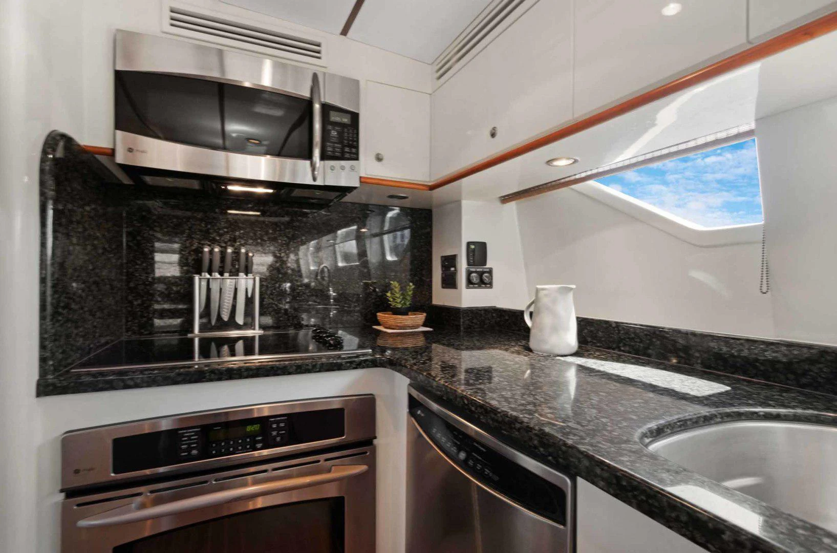 a kitchen with a microwave oven and a stove aboard B HAPPY Yacht for Sale