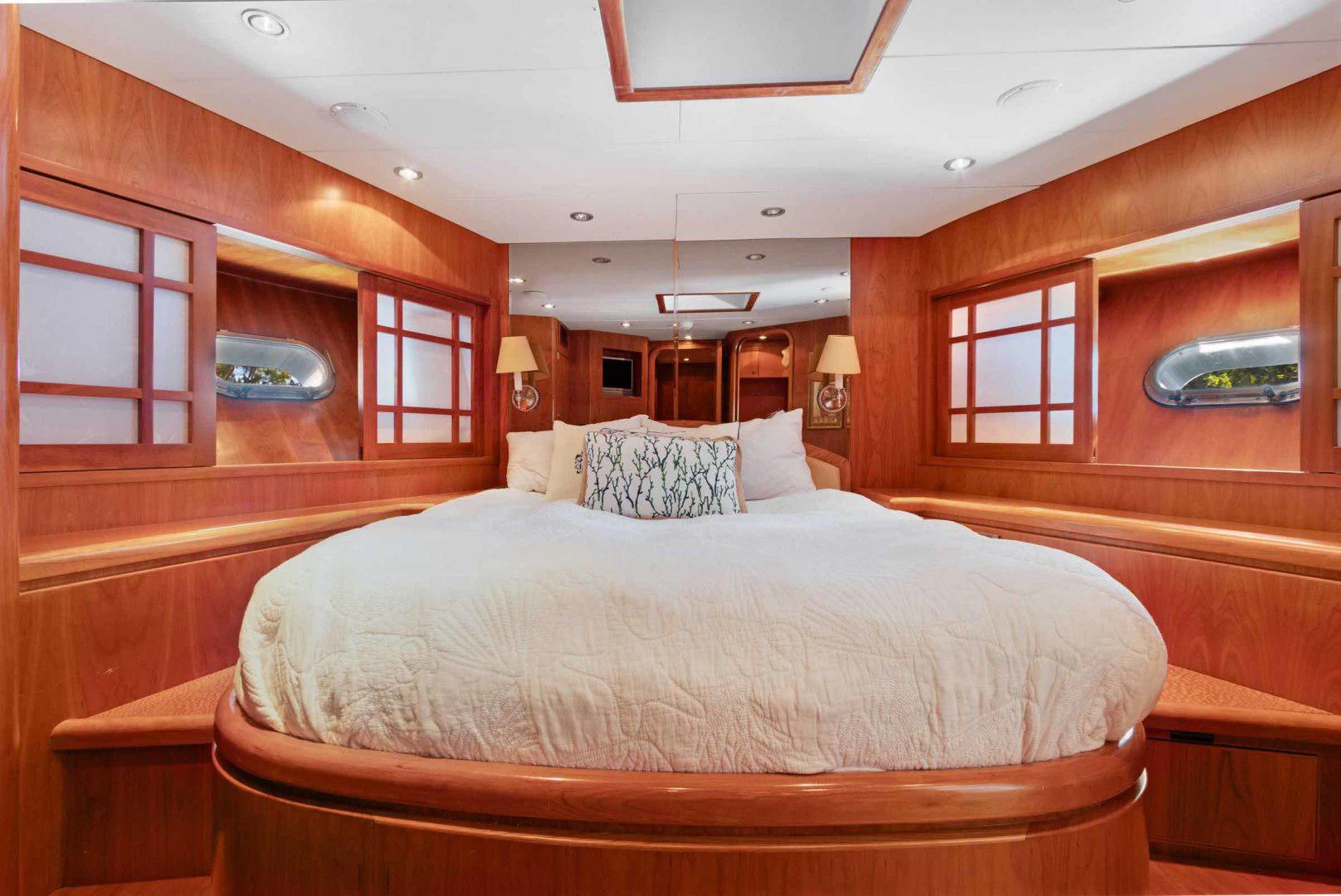 a bedroom with a bed and a mirror aboard B HAPPY Yacht for Sale