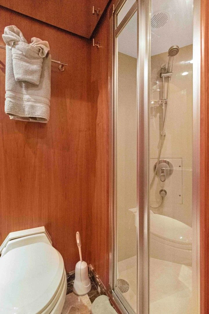 a bathroom with a glass shower door aboard B HAPPY Yacht for Sale
