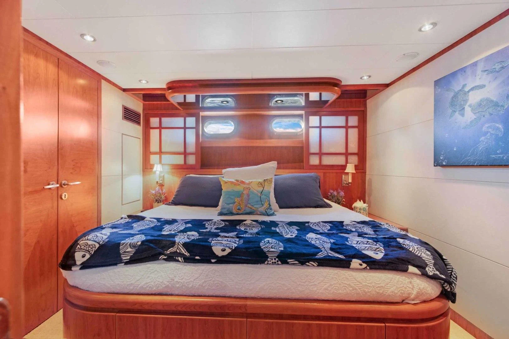 a bed with blue sheets aboard B HAPPY Yacht for Sale