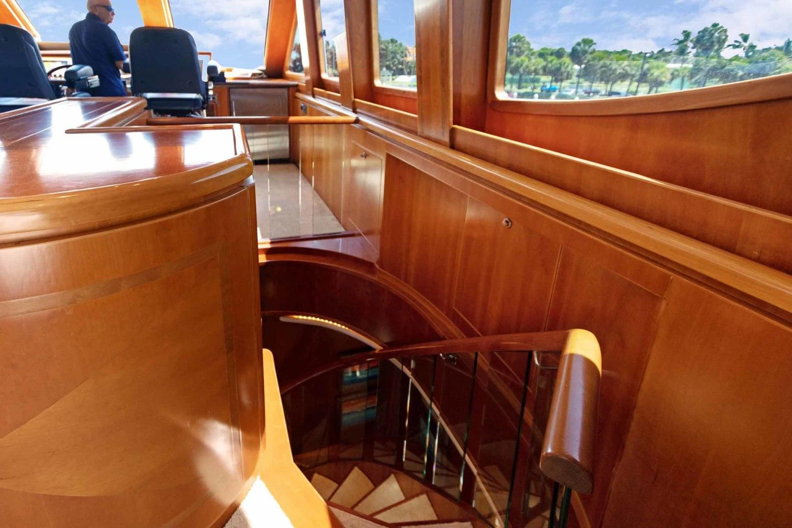 a wooden desk with a chair in a room with a window and a person sitting at the desk aboard B HAPPY Yacht for Sale