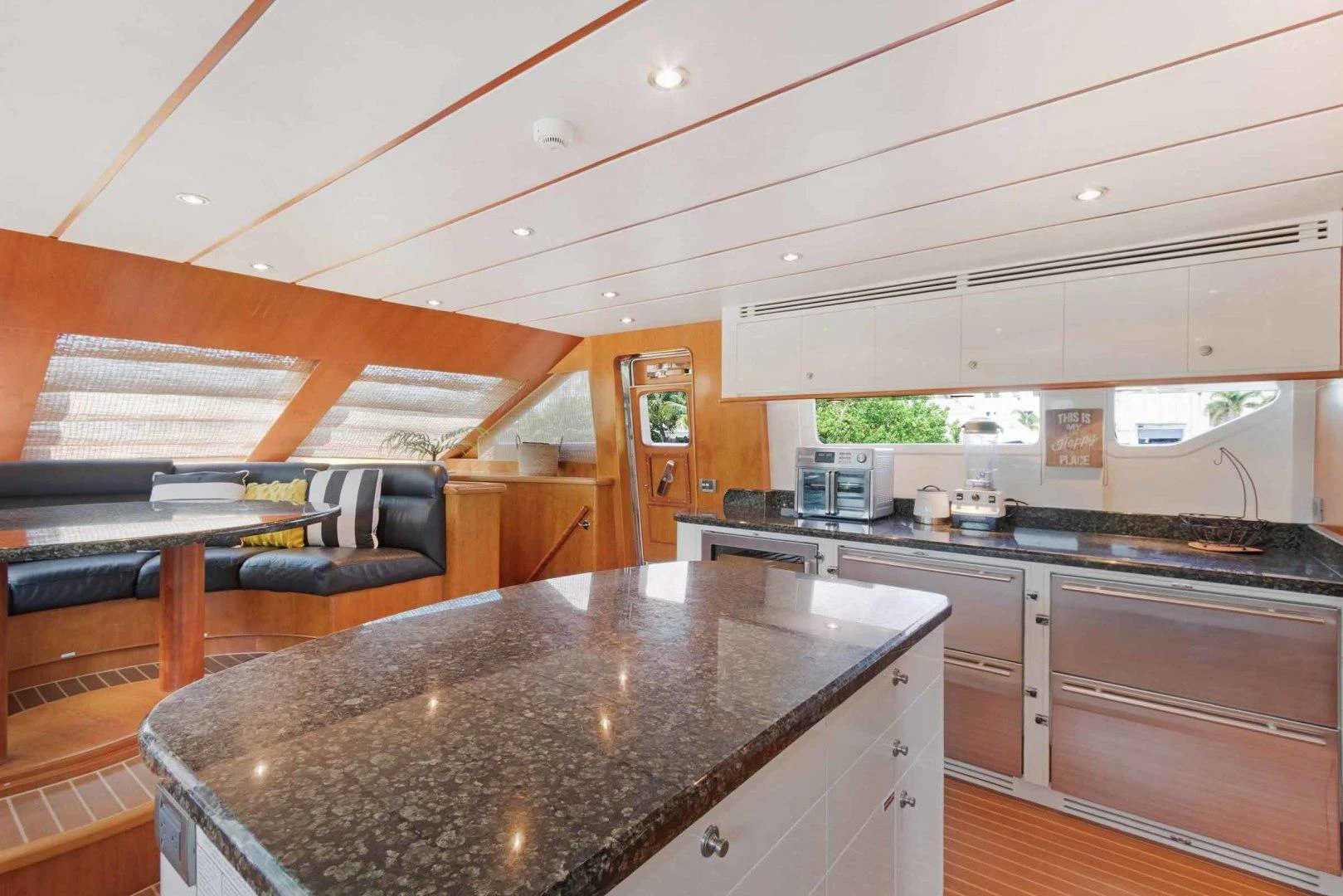 a kitchen with a bar and a couch aboard B HAPPY Yacht for Sale