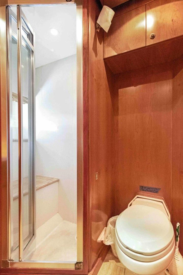 a bathroom with a toilet and a shower aboard B HAPPY Yacht for Sale