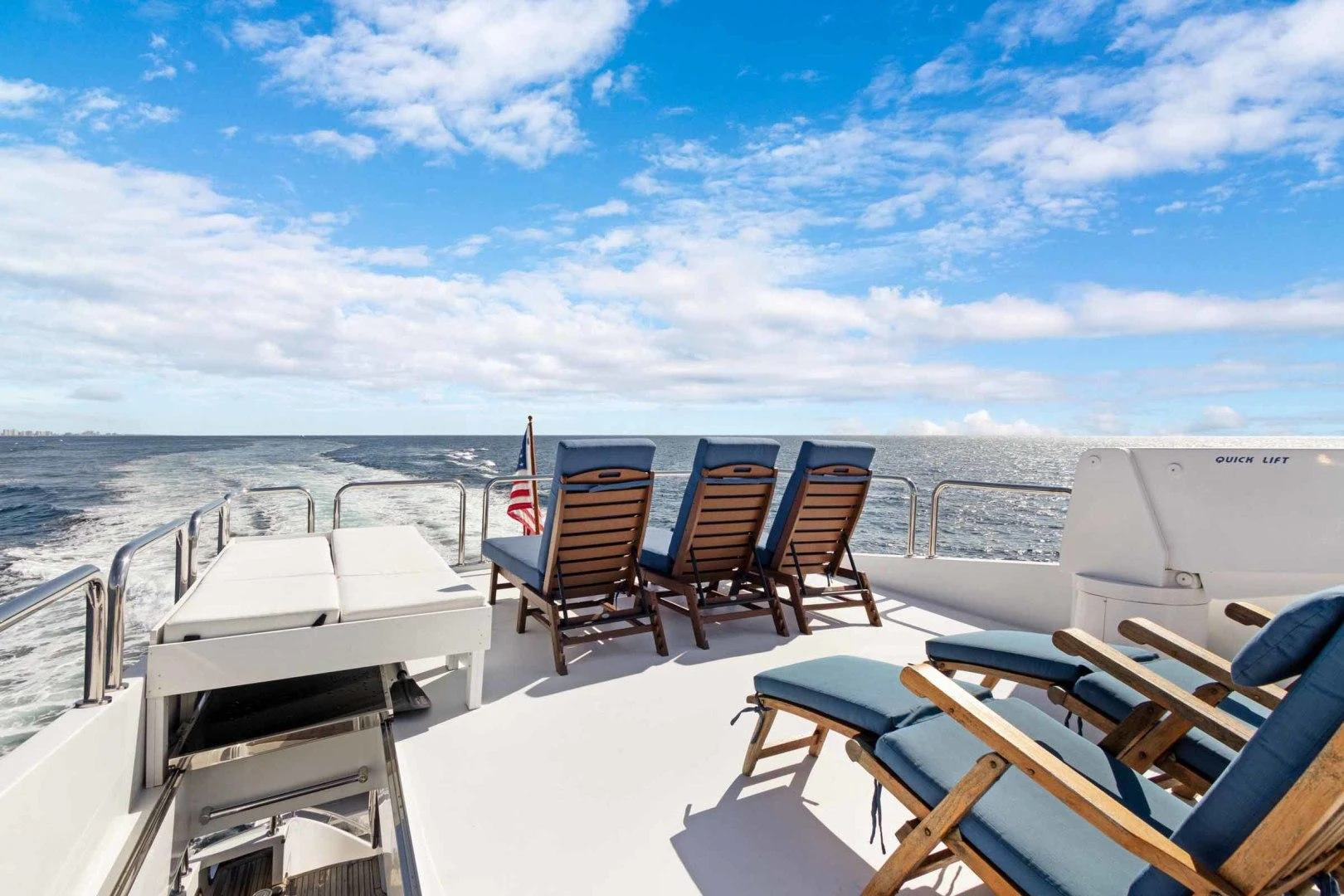a deck with chairs on it aboard B HAPPY Yacht for Sale