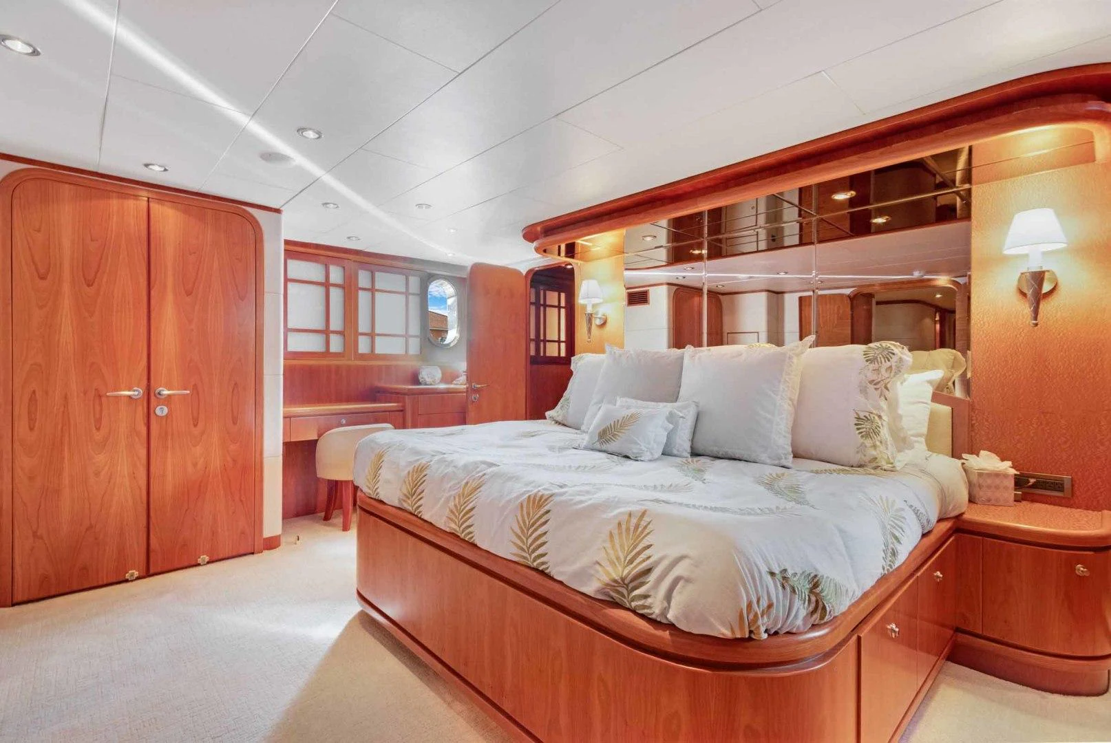 a bedroom with a bed and a desk aboard B HAPPY Yacht for Sale