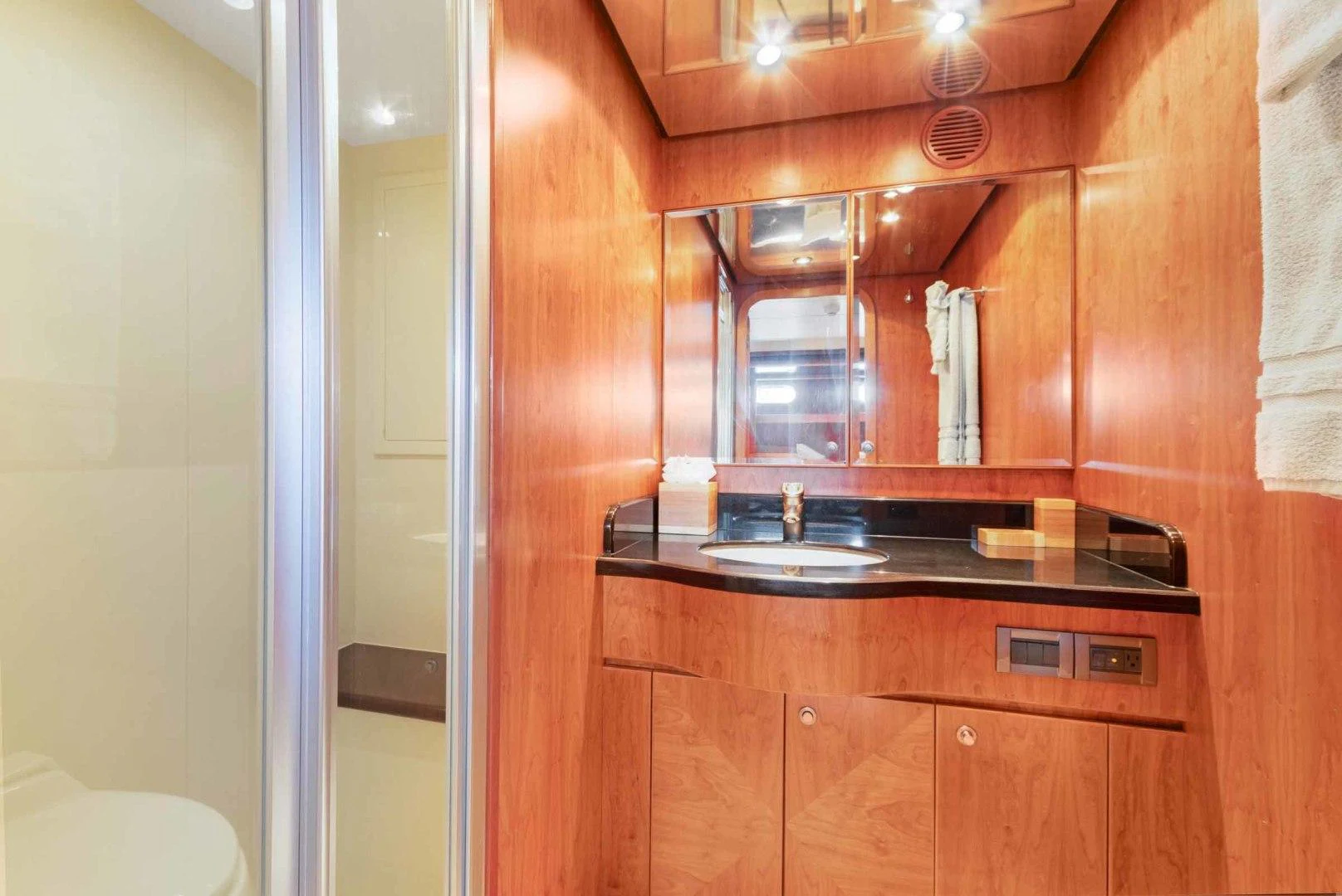a kitchen with wooden cabinets aboard B HAPPY Yacht for Sale