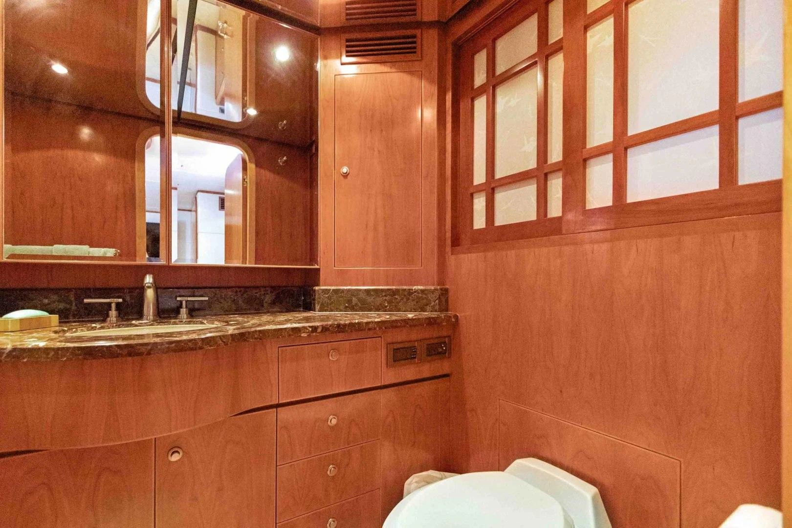 a bathroom with wooden cabinets aboard B HAPPY Yacht for Sale