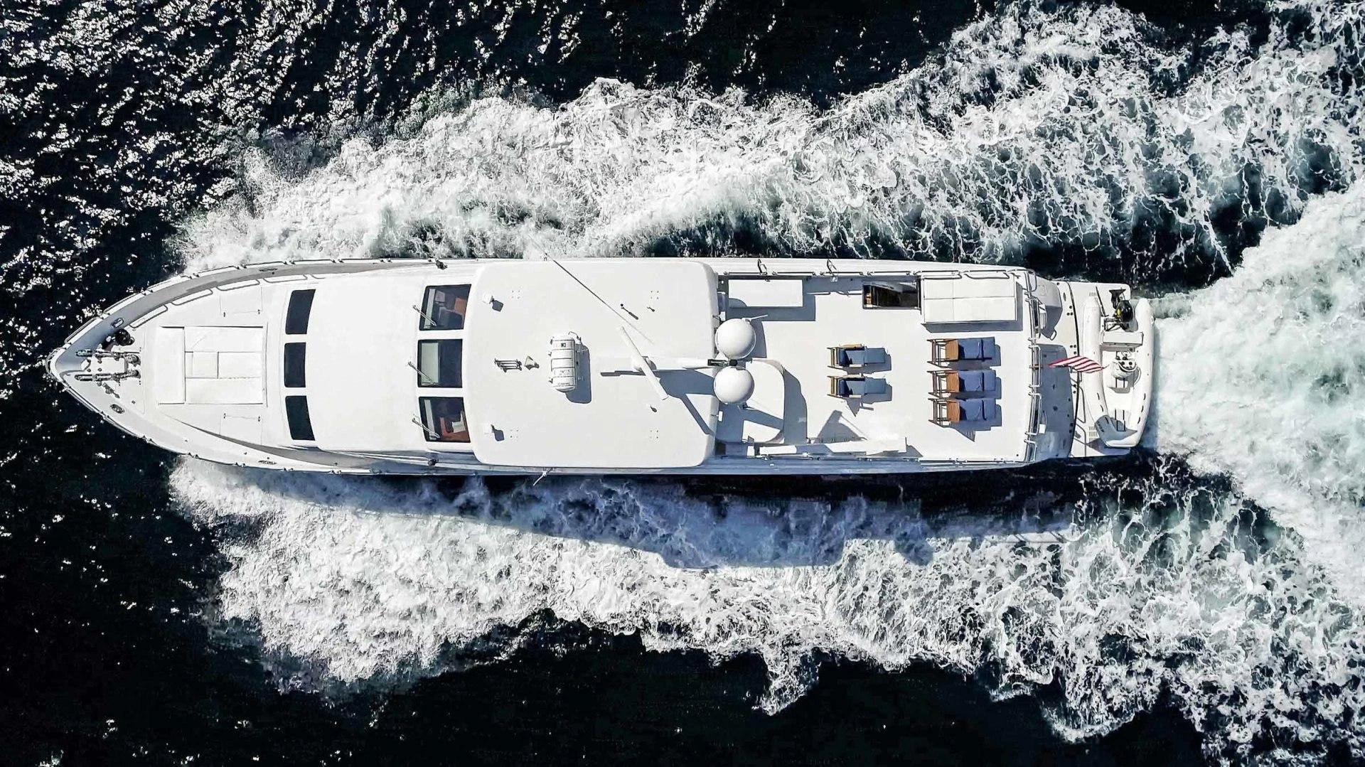 a helicopter flying over a snowy mountain aboard B HAPPY Yacht for Sale
