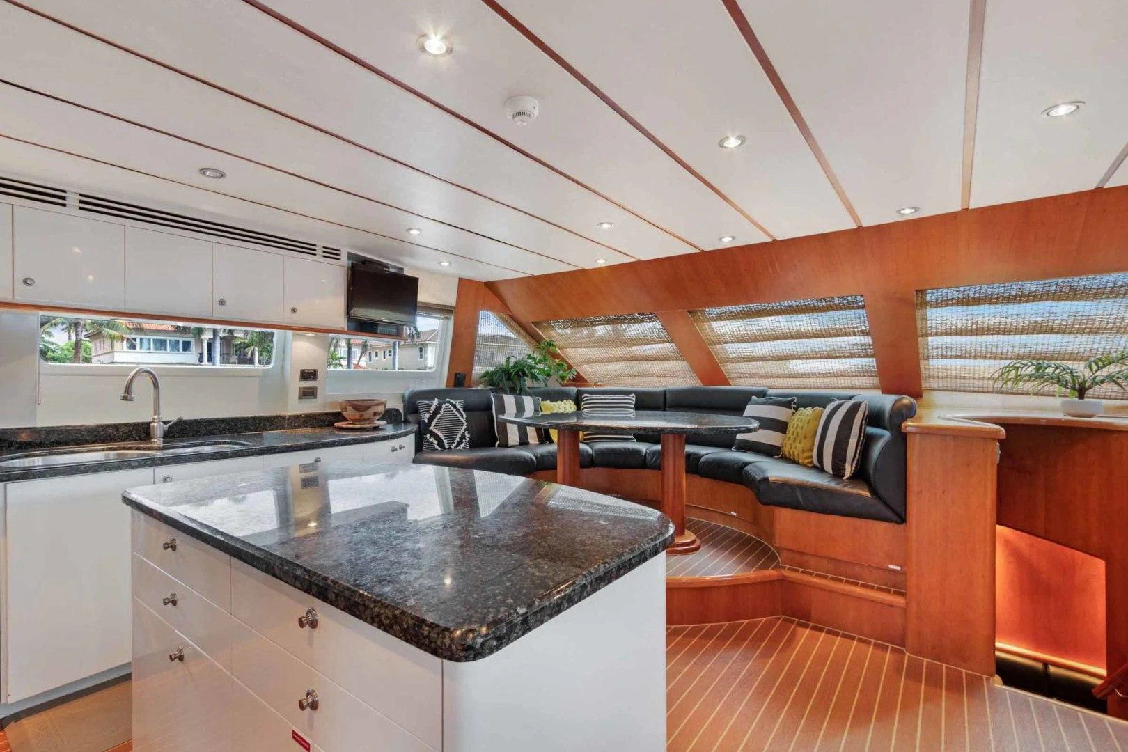 a kitchen with a bar and a couch aboard B HAPPY Yacht for Sale
