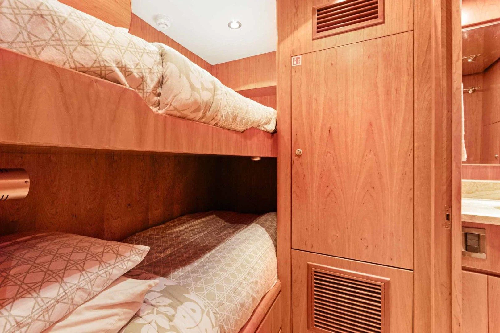 a bed with a wooden headboard aboard B HAPPY Yacht for Sale
