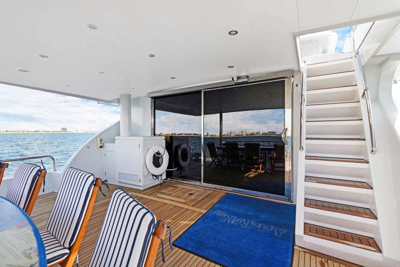 a boat with a large deck aboard B HAPPY Yacht for Sale