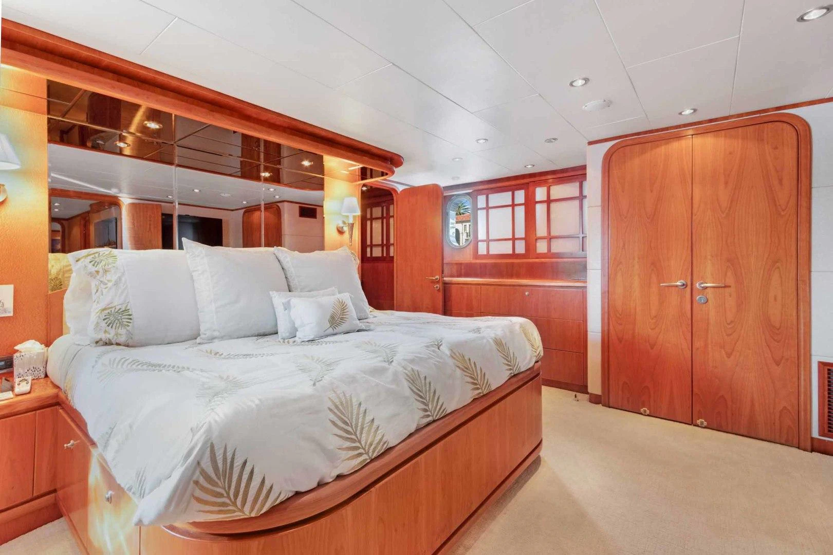 a bedroom with a bed and a closet aboard B HAPPY Yacht for Sale