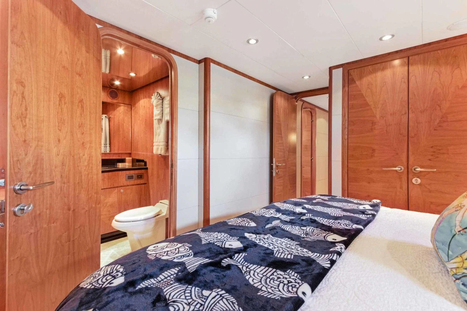 a bedroom with a bed and a closet aboard B HAPPY Yacht for Sale