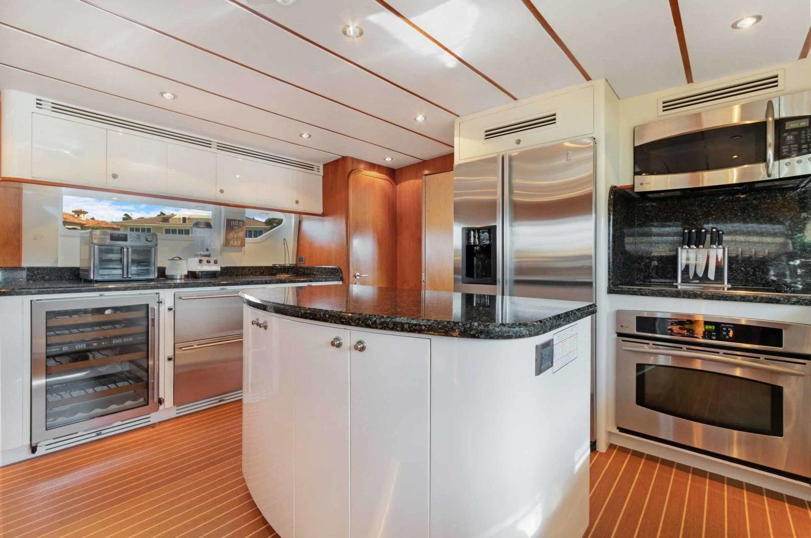 a kitchen with white cabinets aboard B HAPPY Yacht for Sale