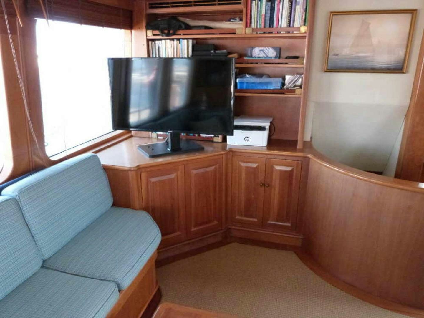a living room with a couch and a television aboard RANGELEY Yacht for Sale