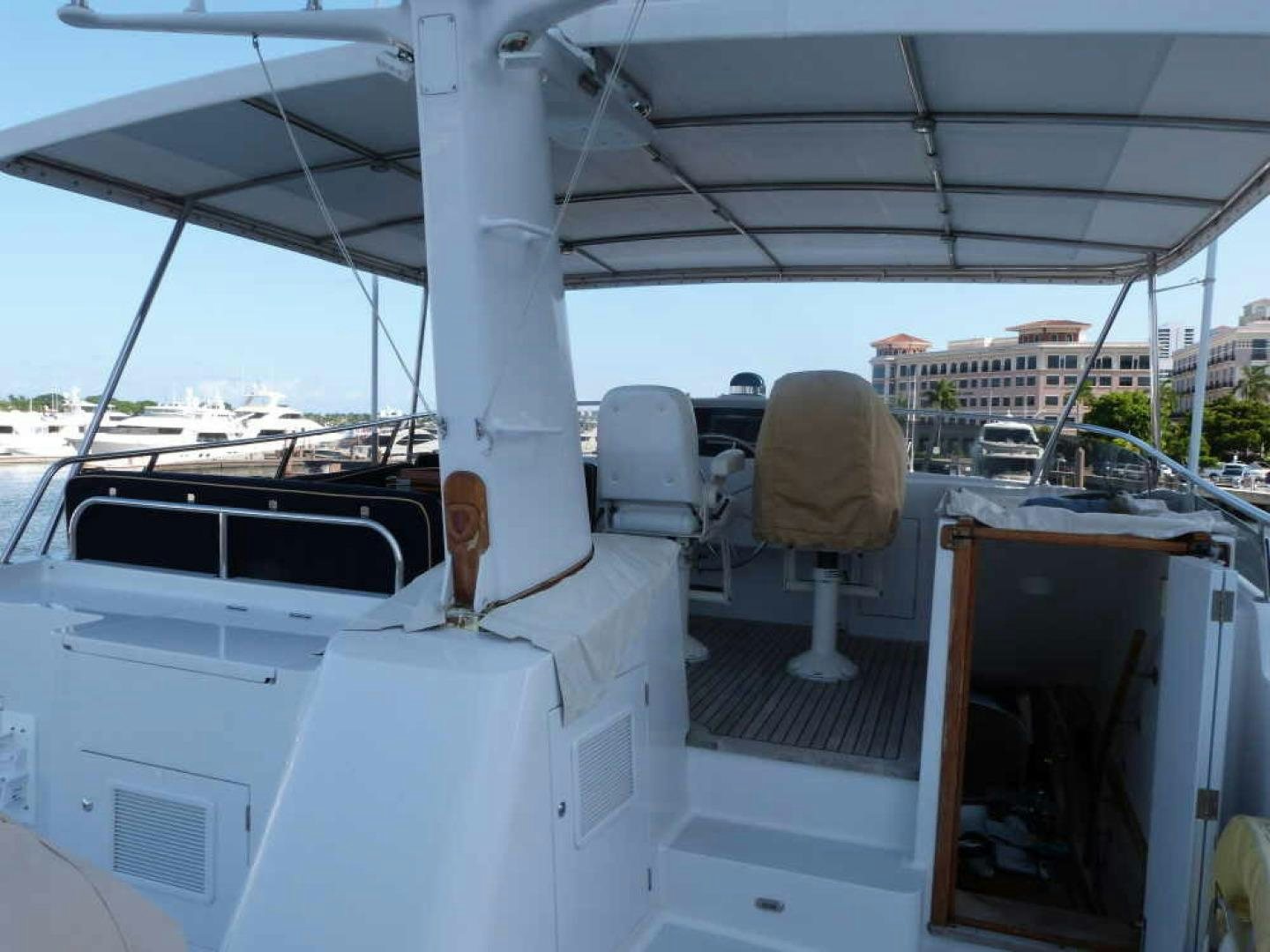a white boat with a chair on the deck aboard RANGELEY Yacht for Sale