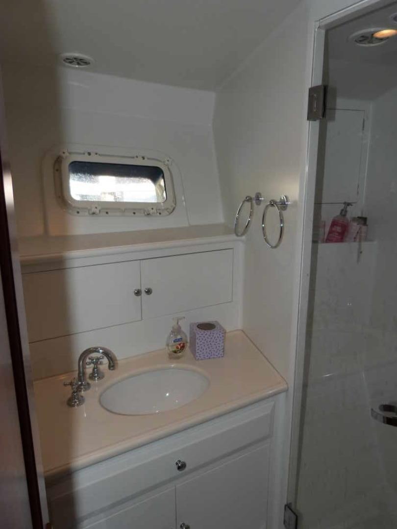 a bathroom with a sink and a mirror aboard RANGELEY Yacht for Sale