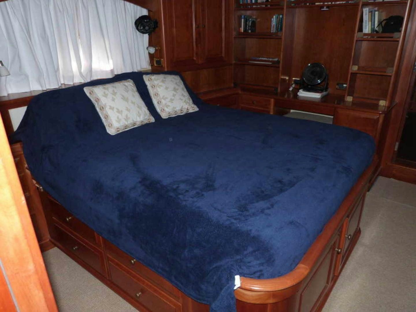 a bed with a blue comforter aboard RANGELEY Yacht for Sale