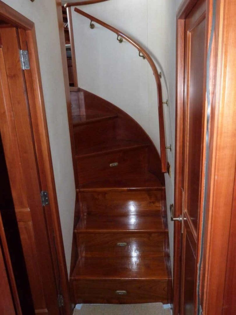 a wooden staircase with a wood railing aboard RANGELEY Yacht for Sale