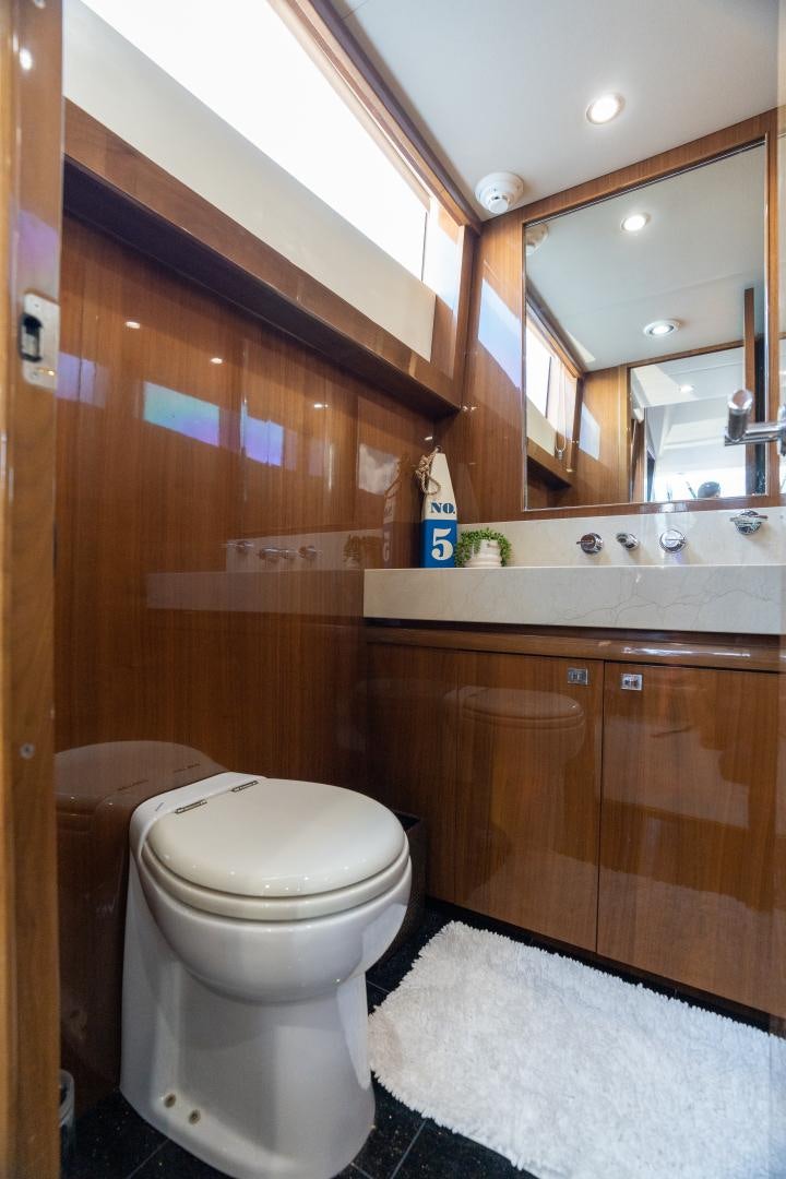 a bathroom with a toilet and a mirror aboard STEPHANIE Yacht for Sale