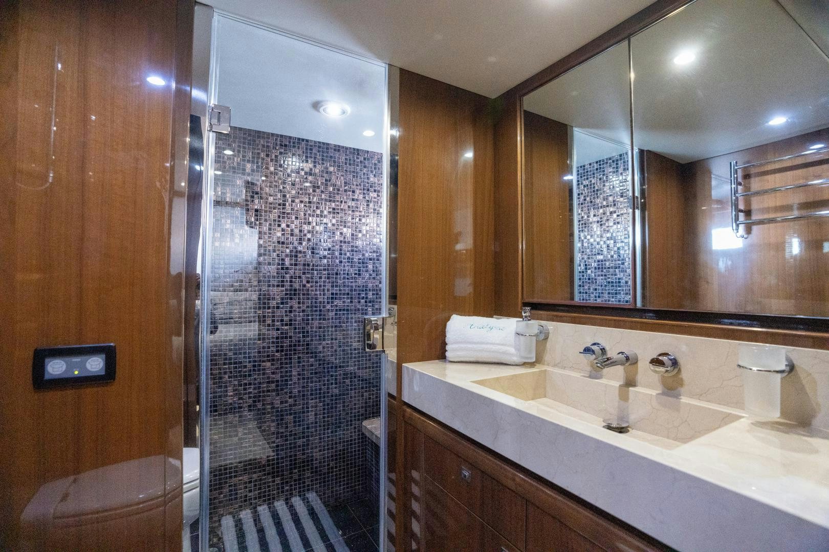 a bathroom with a glass shower aboard STEPHANIE Yacht for Sale