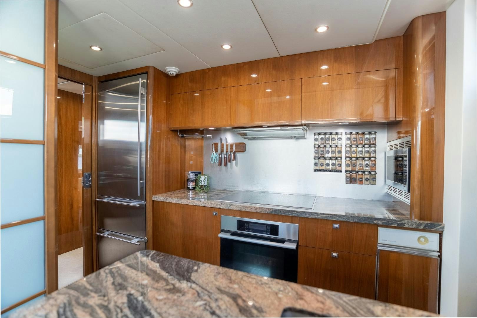 a kitchen with wooden cabinets aboard STEPHANIE Yacht for Sale