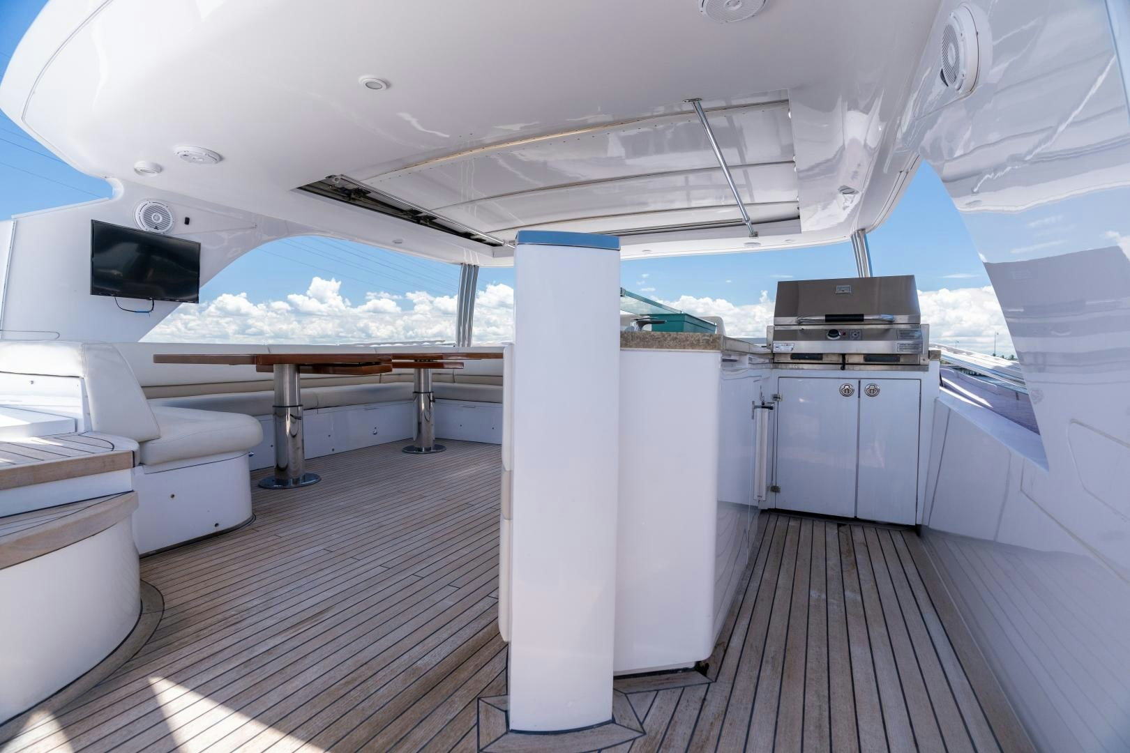 a boat with a deck and a table and chairs aboard STEPHANIE Yacht for Sale