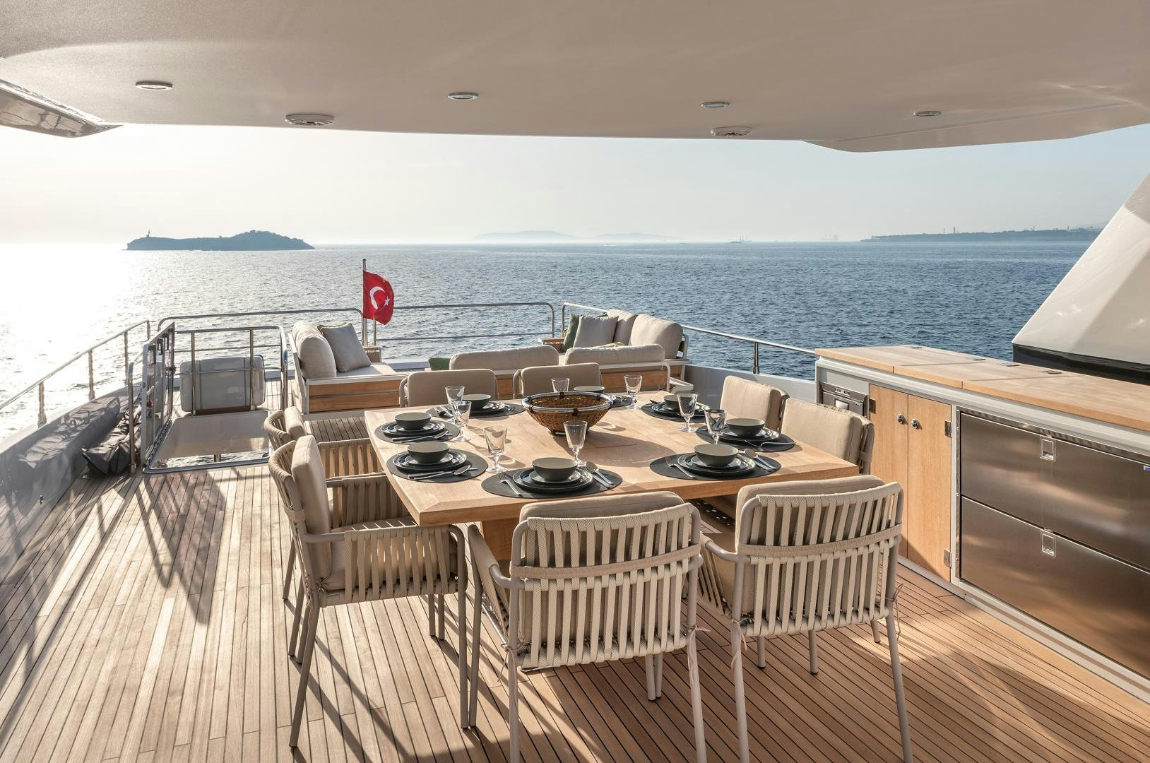 a room with a table chairs and a view of the ocean aboard NUMARINE 22XP Yacht for Sale