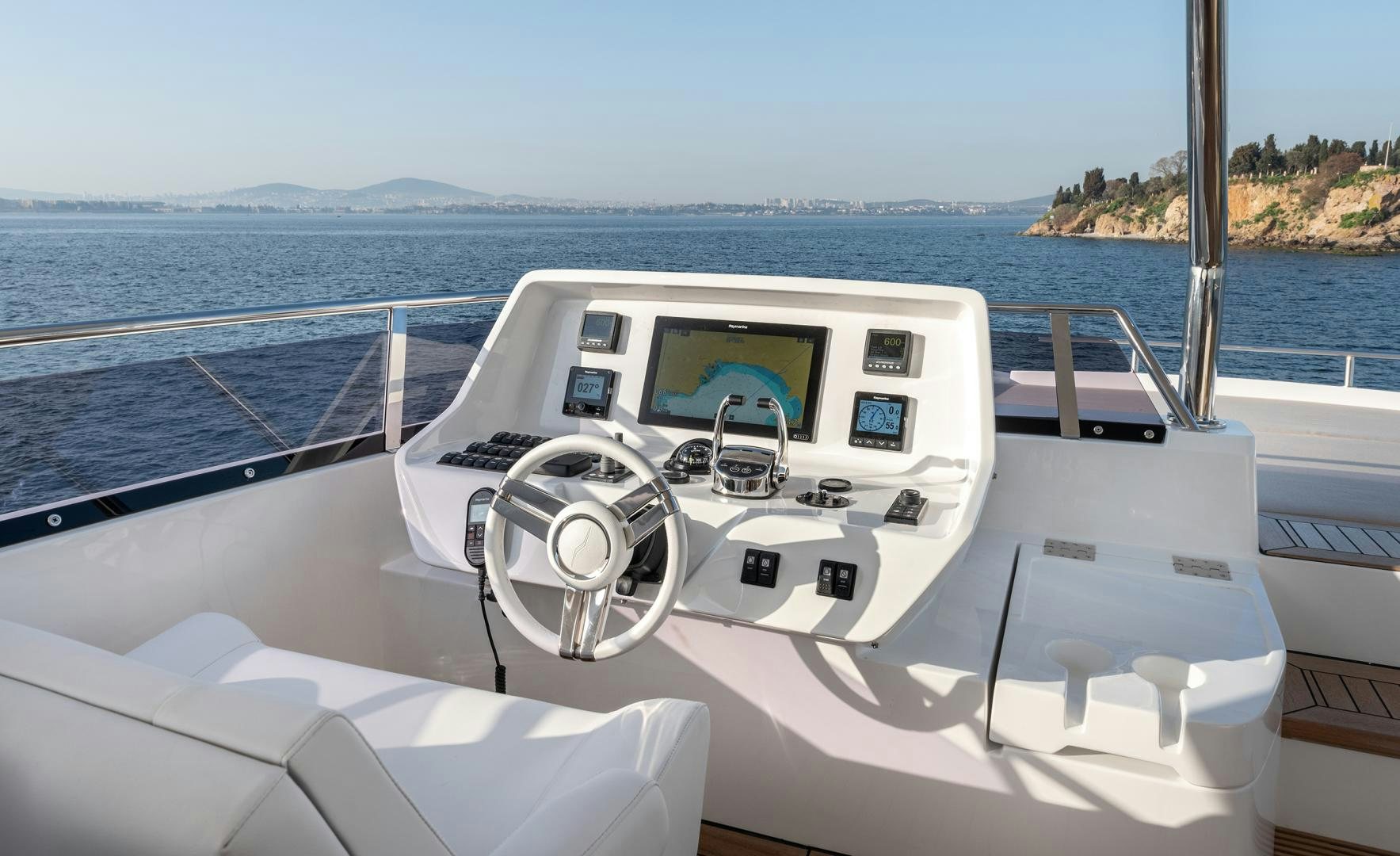 a boat with a steering wheel and a boat on the water aboard NUMARINE 22XP Yacht for Sale