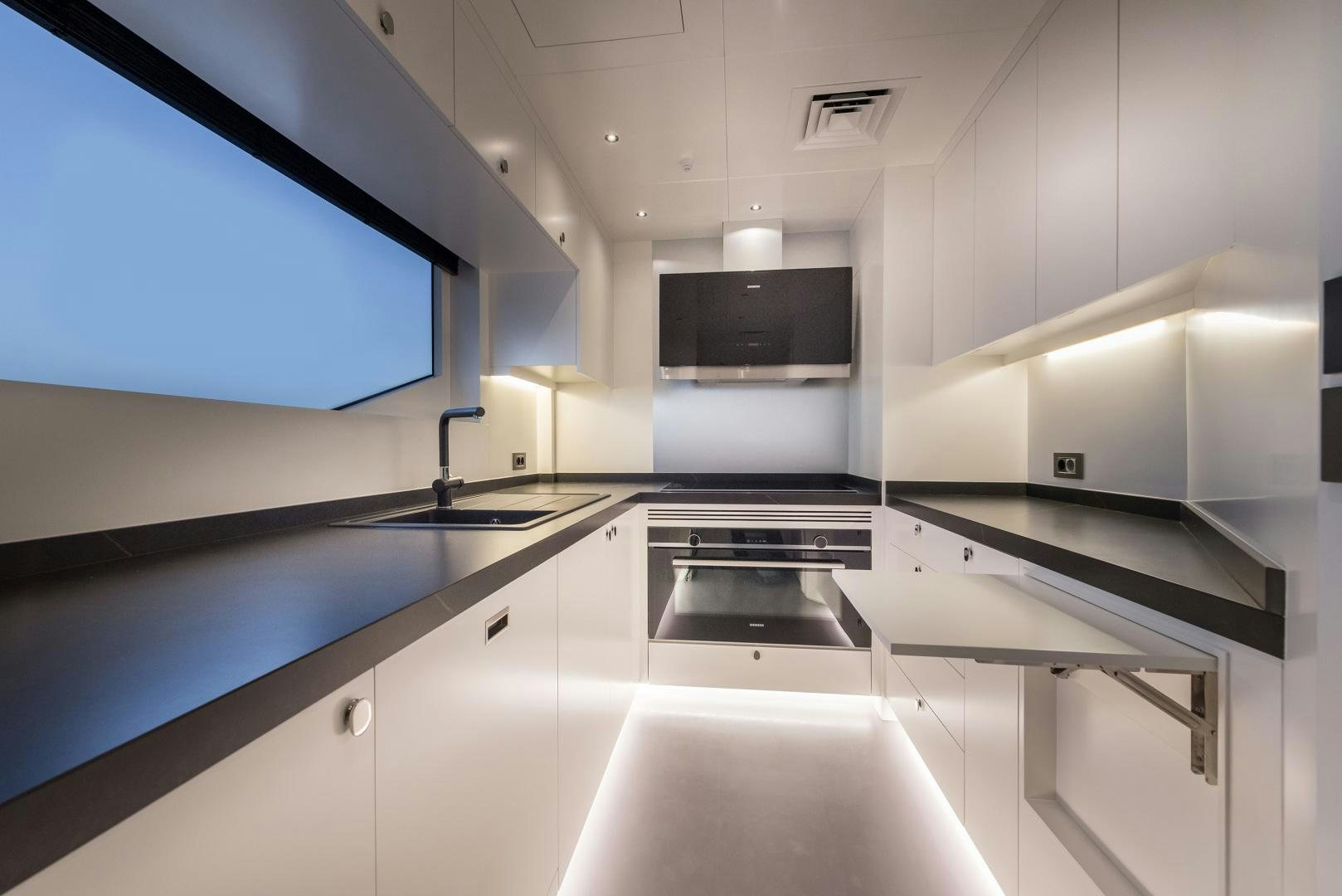 a kitchen with white cabinets aboard NUMARINE 22XP Yacht for Sale
