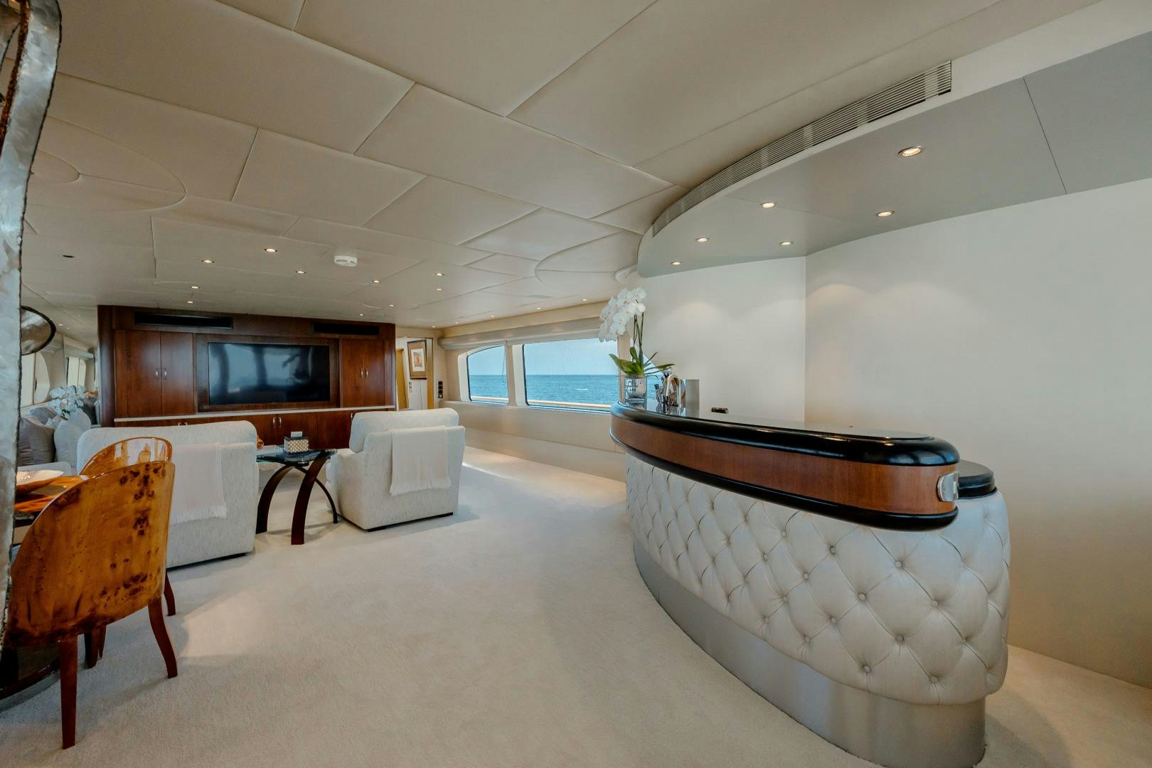 a large white room with a large white tub and a wood cabinet aboard CAPRICE Yacht for Sale