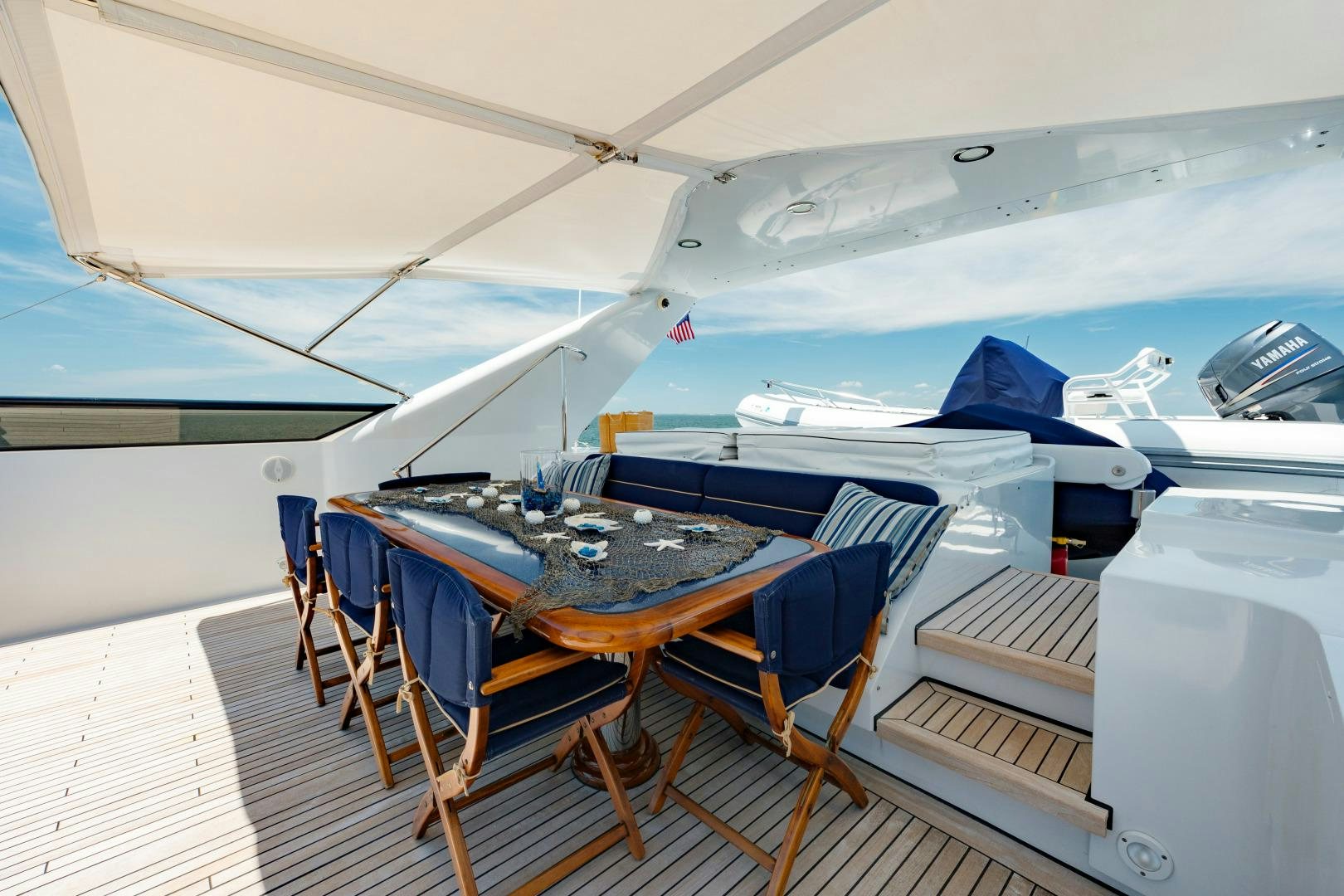 a tent with a table and chairs aboard CAPRICE Yacht for Sale