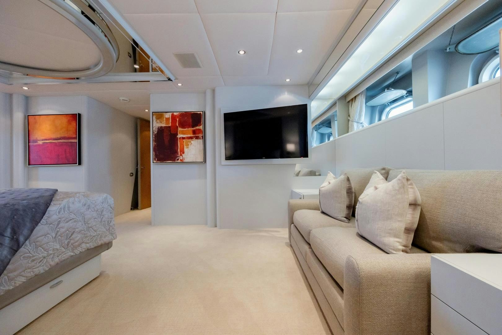 a room with couches and a tv aboard CAPRICE Yacht for Sale
