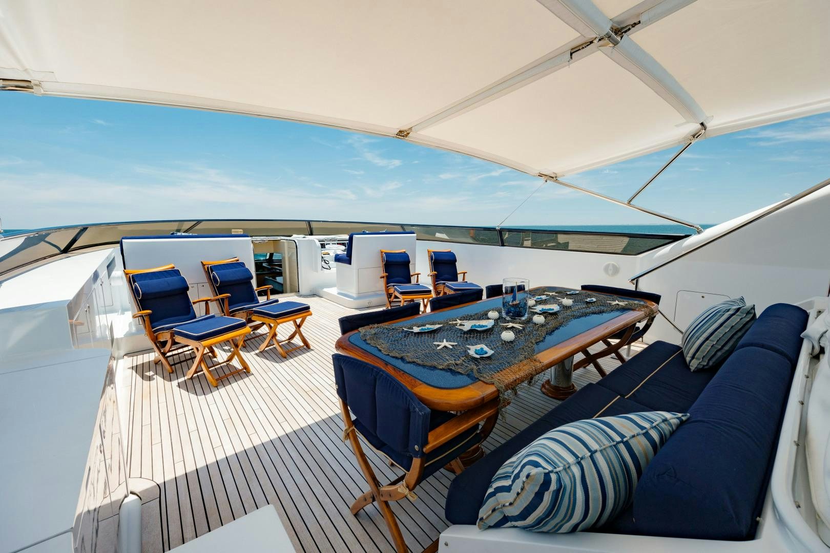 a tent with a table and chairs aboard CAPRICE Yacht for Sale
