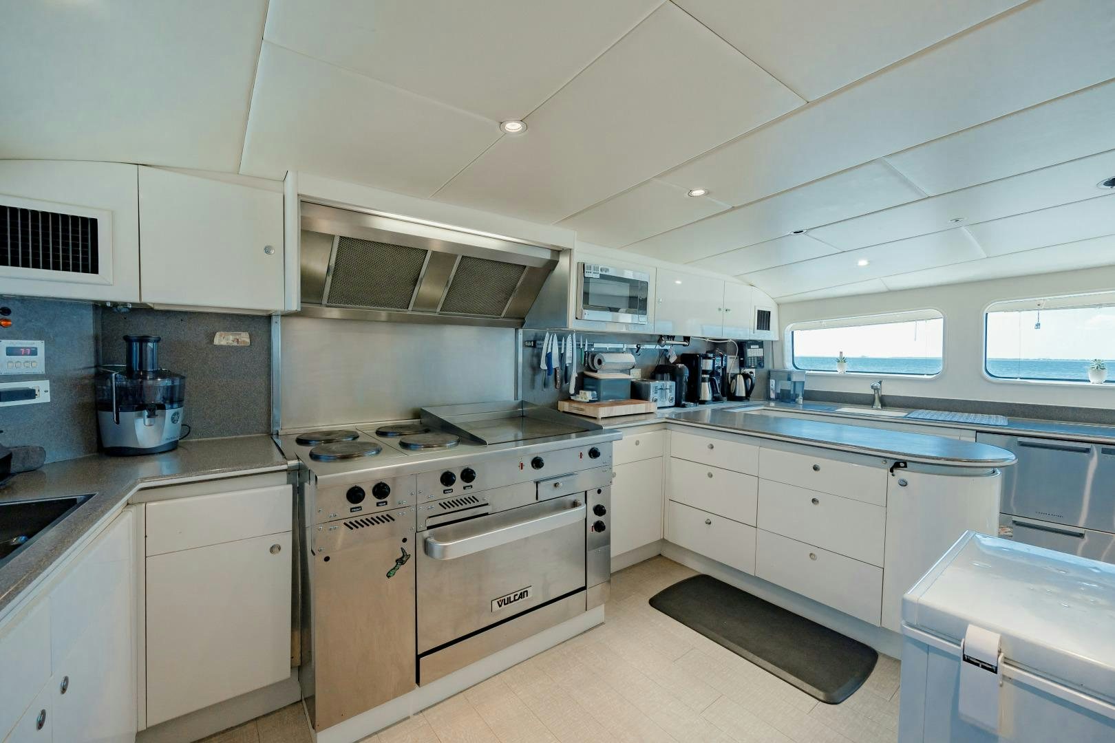 a kitchen with white cabinets aboard CAPRICE Yacht for Sale
