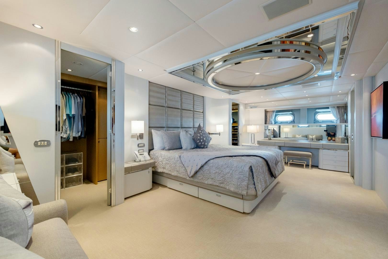 a bedroom with a bed and a large fan aboard CAPRICE Yacht for Sale