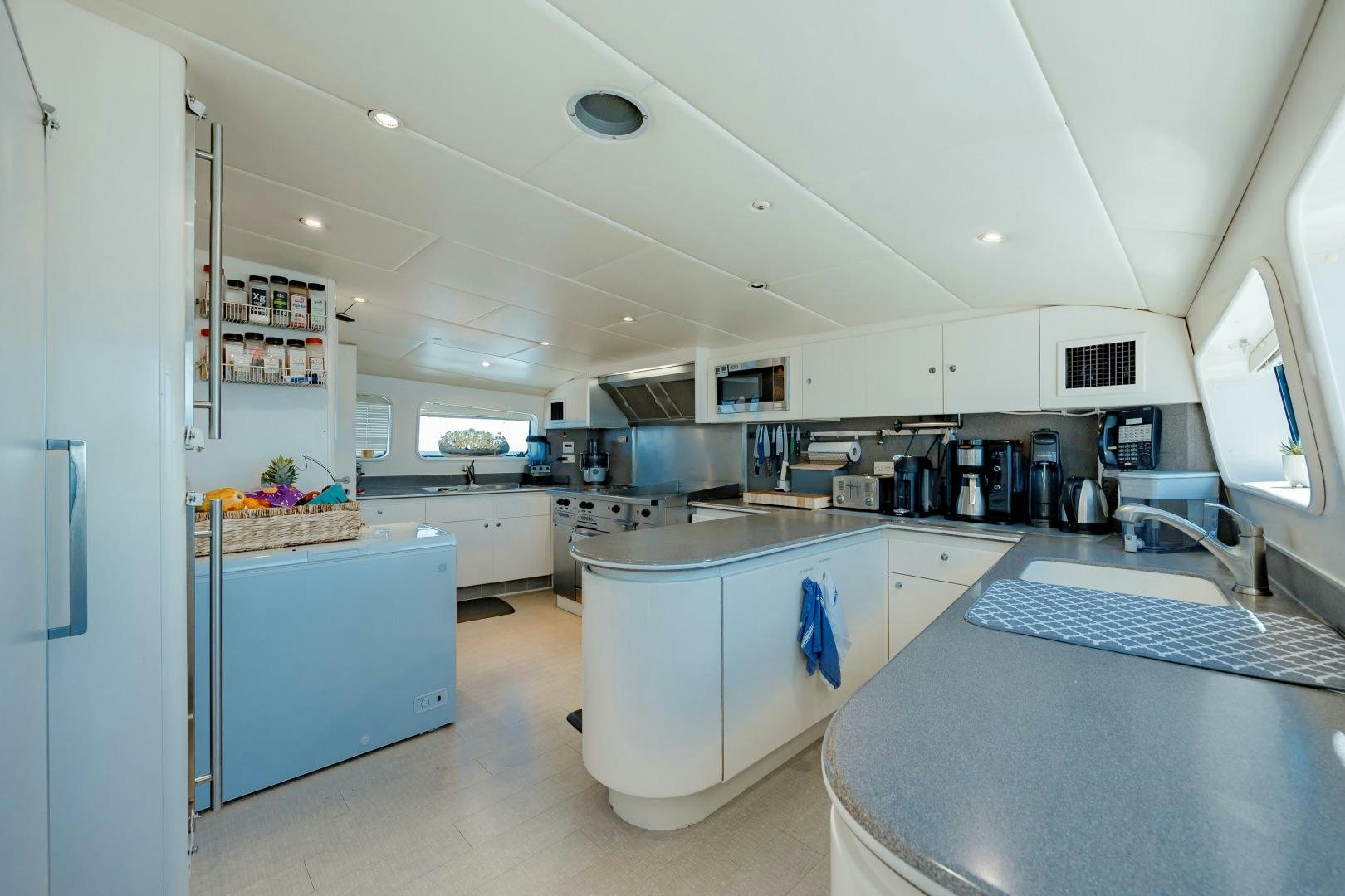 a kitchen with a large island aboard CAPRICE Yacht for Sale