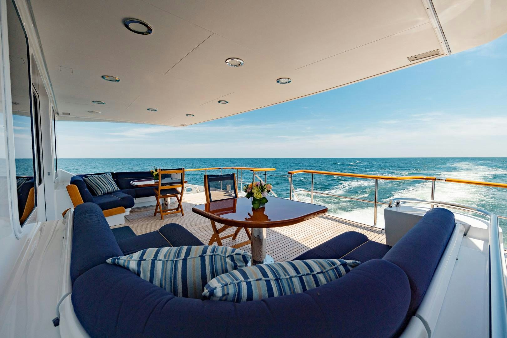 a table and chairs on a boat aboard CAPRICE Yacht for Sale